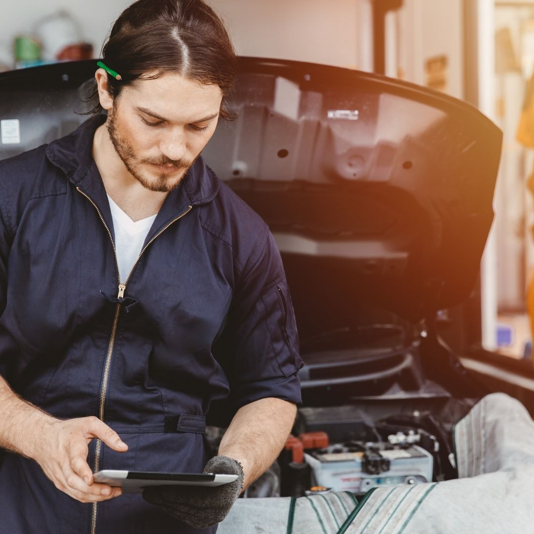 Automotive Technician doing an Inspection on an ipad of a vehicle